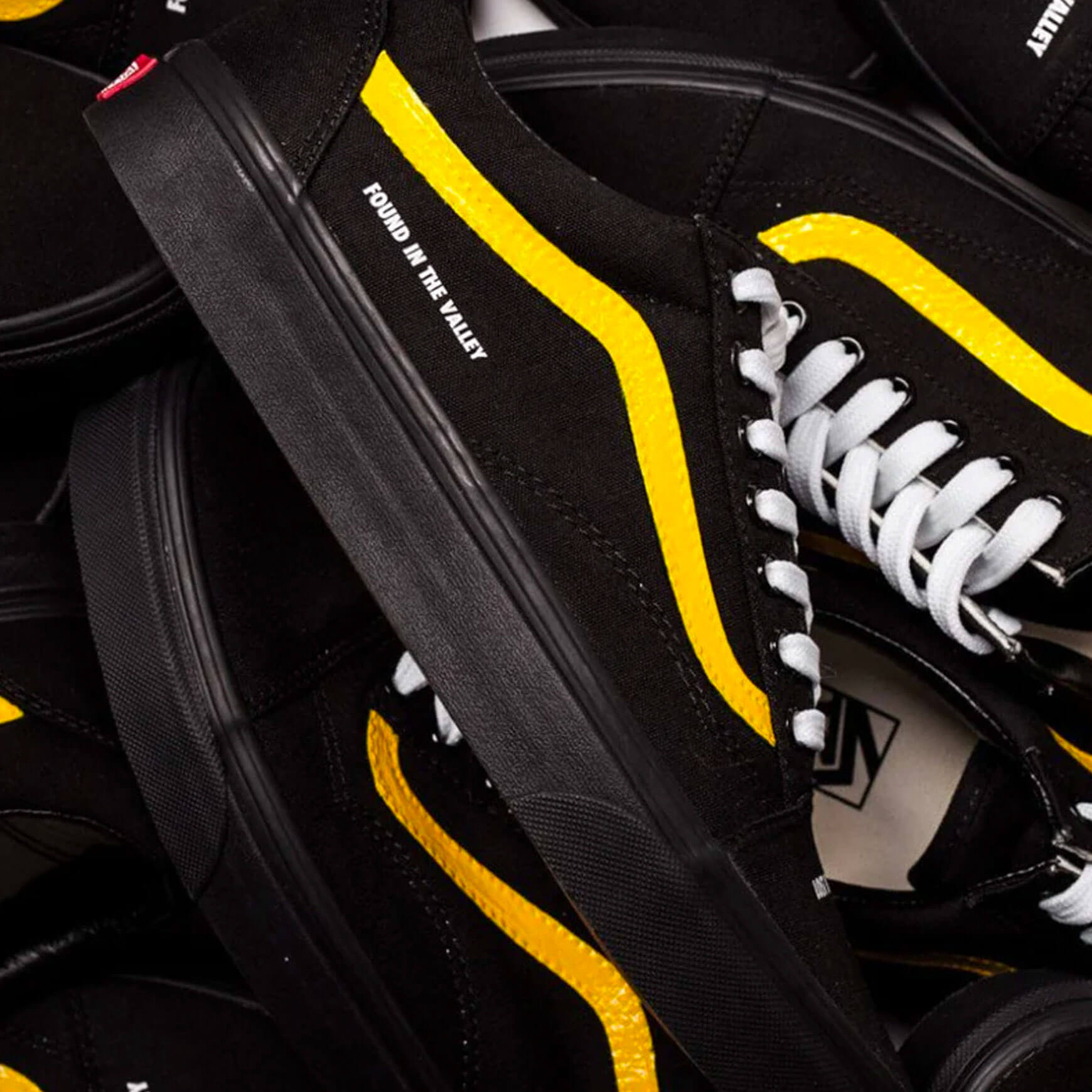 Black vans with yellow 2024 stripe